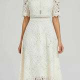 Irina – Midi suknelė su nėriniais ir išpjovimais" can be rewritten as "Irina – Midi Dress with Lace and Cut-Outs.