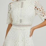 Irina – Midi suknelė su nėriniais ir išpjovimais" can be rewritten as "Irina – Midi Dress with Lace and Cut-Outs.